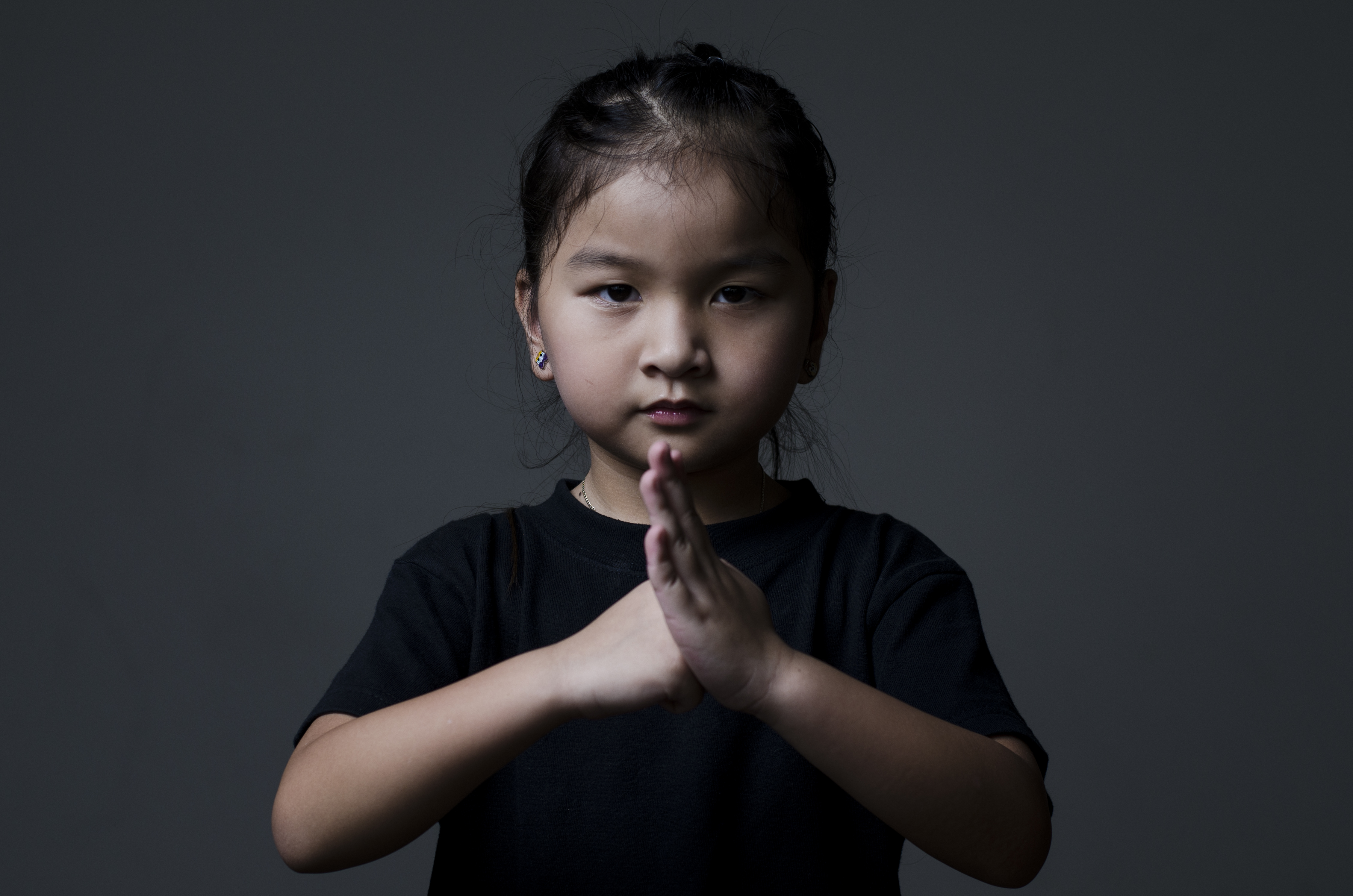 Leah in Wushu greeting gesture as a toddler